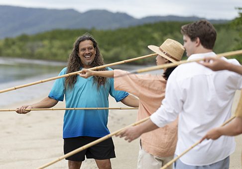 Nov-21 Indigenous guide showing a group how to spear fish from the beach